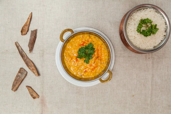 Dal tarka with plain rice served in a dish isolated on table top view of indian spices food