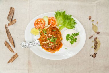 Mutton Raan masala with gravy and salad served in a dish isolated on table top view of indian spices food