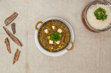 Palak panir or palak paneer with plain rice served in a dish isolated on table top view of indian spices food