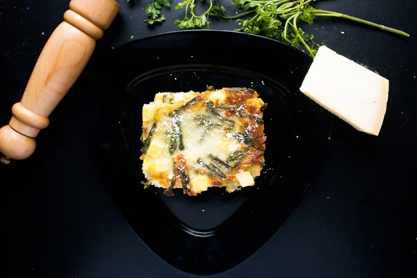 Veggie Lasagnia served in a dish isolated on dark background top view of italian food