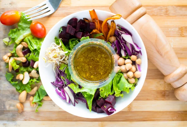 Spring Salad with chickpea, avocado, veggie, spinach, cabbage served in a dish isolated on dark background top view of italian food