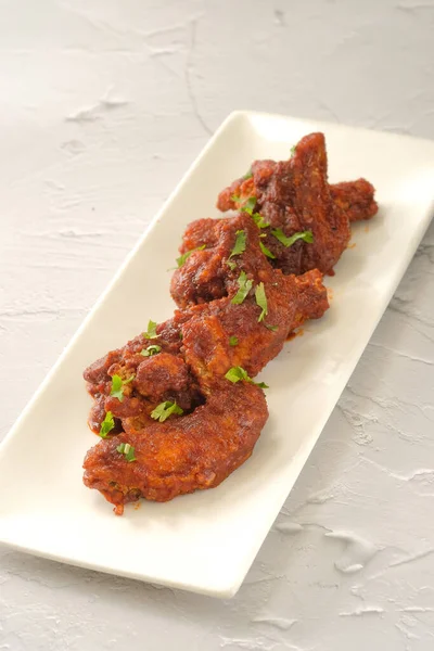 Tavuk kanadı barbeküsü fast food arka planında izole edilmiş bir yemekle servis edilir.