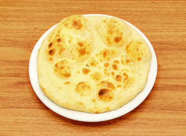 Khamiri Roti Nan Nun Roti Tandoori Chapati Pita 面包放在木制桌旁的盘子里 可以看到印度的面食 — 图库照片