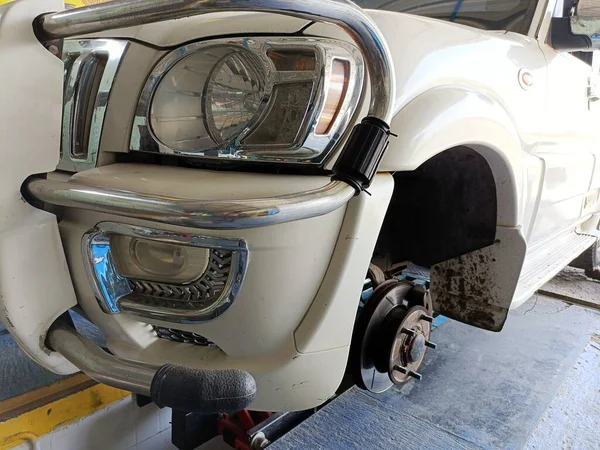 close up of Car without Wheel in Garage