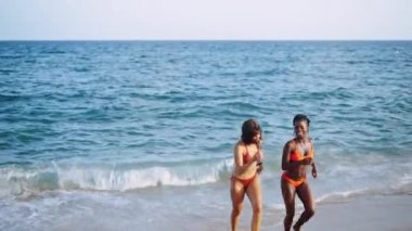 Denizden gelen güzel ırklar arası genç kadınlar.