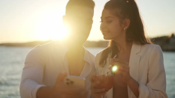 Loving ethnic couple kissing and taking selfie on smartphone — Stock Video