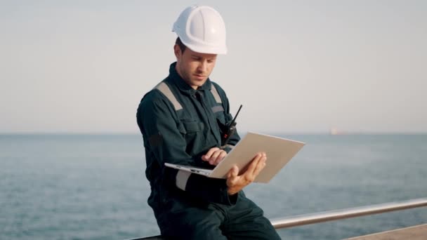 Inspecteur portuaire concentré superviseur travaillant sur un ordinateur portable dans un terminal maritime — Video
