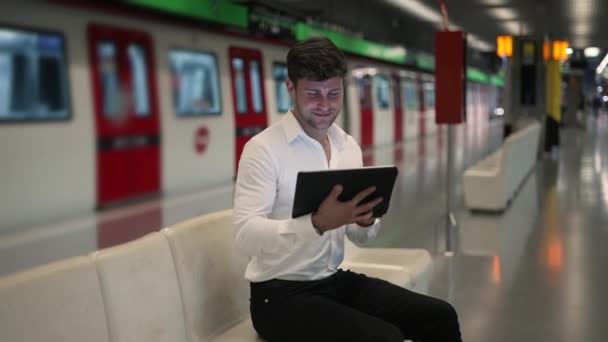 Glad businessman using tablet in subway — Stock Video