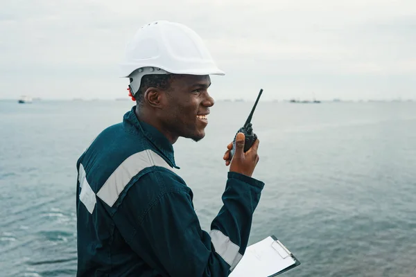 Cheerful black seaman speaking on radio — Stockfoto