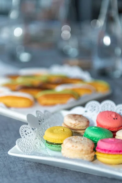 Macarons on the festive table. Plate with openwork napkin. close up — Stock Photo, Image