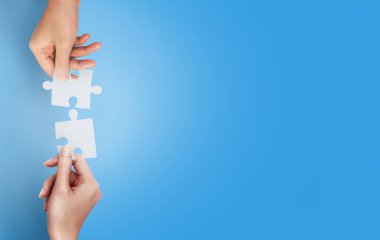 Ellerin birbirine uyumlu iki yapboz ile takım çalışması kavramının birleşiminin üst görünümü. kopyalama alanı ile.