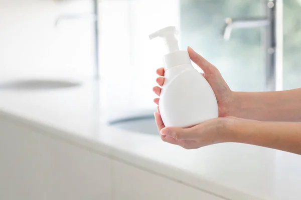 Hands Holding Soap Pressed Bottle Bathroom Sink Background — Stock Photo, Image