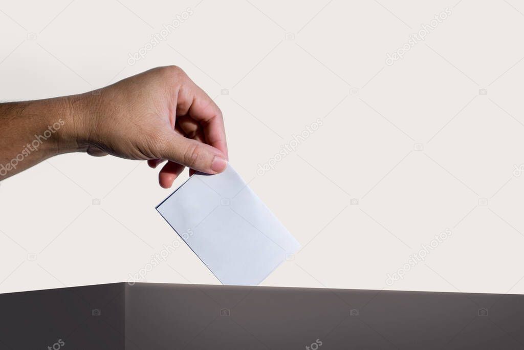 Hand holding ballot paper for election vote at place election background. Election vote concept.