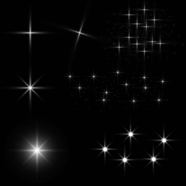 Parlayan ışıkların, alevlerin, patlamaların ve yıldızların etkisi. Siyah arkaplanda özel efekt