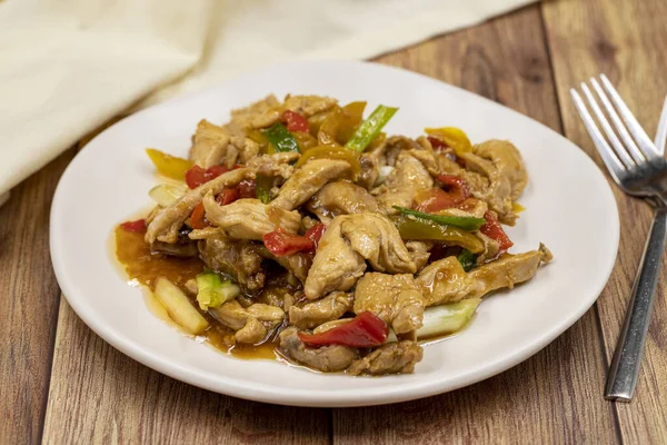 Chinese chicken dish. Chicken with olive oil and soy sauce. Traditional Chinese dish prepared with garlic, onion, capia pepper and green pepper