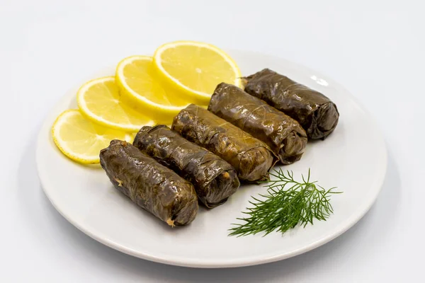 Stuffed grape leaves with olive oil on a white background. Traditional Turkish cuisine delicacies. Delicious dolma (yaprak sarma). Horizontal view. Close up