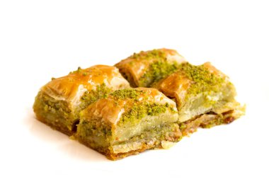 Beyaz arka planda Pistachio baklava tatlısı izole edilmiş. Türk tatlısı konsepti. Fıstıklı baklavayı kapatın. Şerbet tatlı Akdeniz fırını seçici odak noktası. Yatay görüş. Yerel adı fistikli baklava