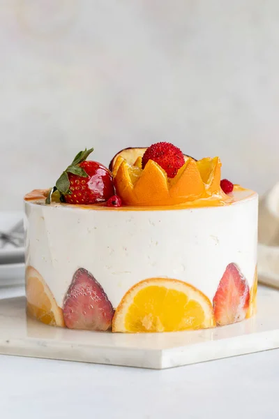 Fruit Parfait Cake on a white background. Fruit cake with white cream. Close-up. Vertical view