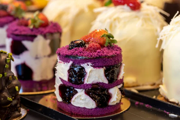 Fruity cake. Small cakes on display at the patisserie counter