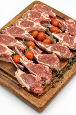 Kuzu pirzolası beyaz arka planda izole edilmiş. Tahtada çiğ kuzu pirzolası. Kapat.