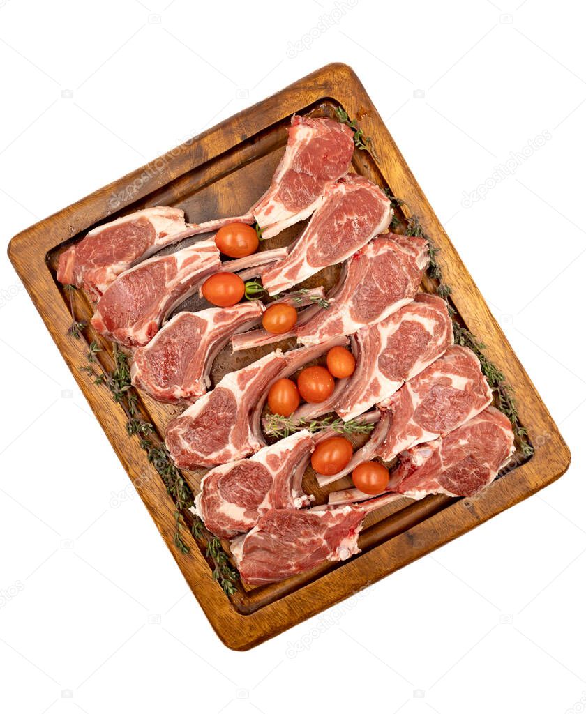 Lamb chops isolated on a white background. Raw lamb chops on wood serving board. Top view
