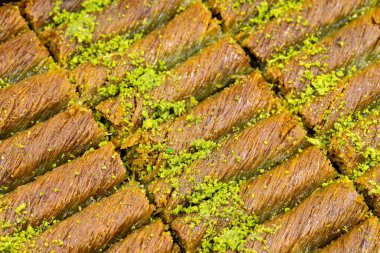 Pistachio kadayif dessert. Traditional Turkish cuisine delicacies. Close-up kadayif dessert. Local name sarma kadayif clipart