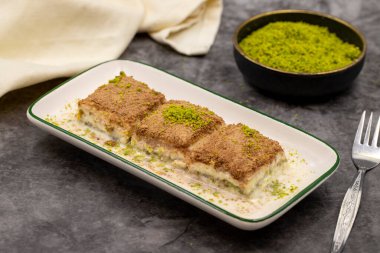 Cold baklava. Baklava with milk on a dark background. Mediterranean cuisine delicacies. Close-up. Local name soguk baklava