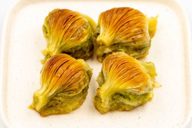 Midye baklavası. Beyaz arka planda Pistachio baklava izole edilmiş. Akdeniz mutfağı lezzetlidir. Yakın plan. yerel adı Midye Baklava