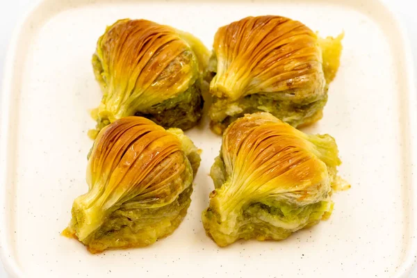 Midye baklavası. Beyaz arka planda Pistachio baklava izole edilmiş. Akdeniz mutfağı lezzetlidir. Yakın plan. yerel adı Midye Baklava