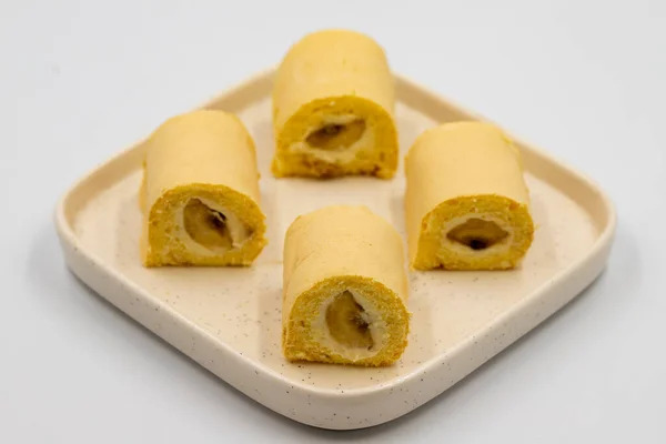 Banana roll cake. Roll cake with banana filling on a white background. close up
