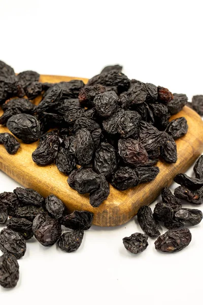 Beyaz arka planda siyah kuru üzümler. Sağlıklı ve özgür