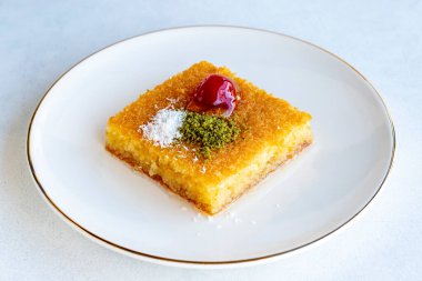 Kadayif dessert with pistachio on a white background. Traditional Turkish cuisine delicacies. close up
