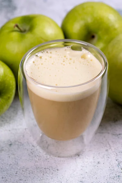 Apple juice. Freshly squeezed juice. Freshly squeezed apple juice in glass on stone background. Close-up