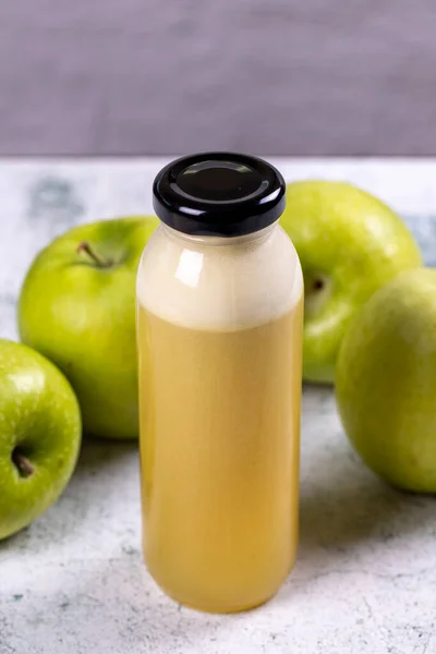 Apple juice. Freshly squeezed juice. Freshly squeezed apple juice in glass on stone background. Close-up