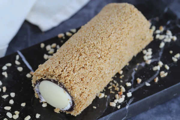 Flowing chocolate roll cake. Chocolate cake on dark background. close up