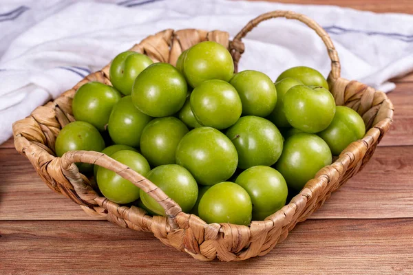 Green Plum Wood Background Pile Green Plums Basket Close — Stockfoto