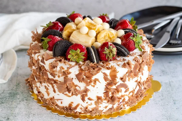 Fruit cake. White chocolate and fruit cake on a stone background. Celebration and birthday cake. close up