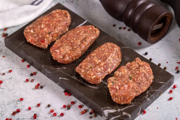 Uncooked Spicy Grilled Meatballs Meatballs Stone Serving Plate Stone Background — стоковое фото