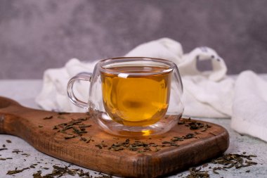 Green tea. Green tea in a wooden serving dish on a stone background. Healthy drinks. Herbal tea concept. close up