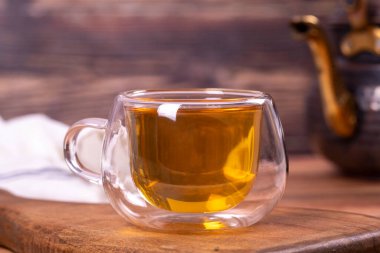 Green tea. Green tea brewed with copper teapot on stone background. Healthy drinks. Herbal tea concept. close up