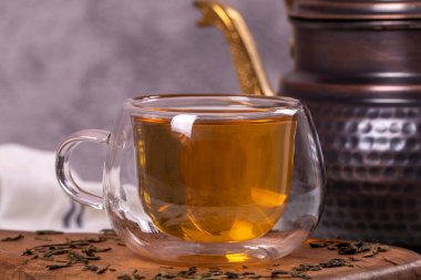 Green tea. Green tea brewed with copper teapot on stone background. Healthy drinks. Herbal tea concept. close up