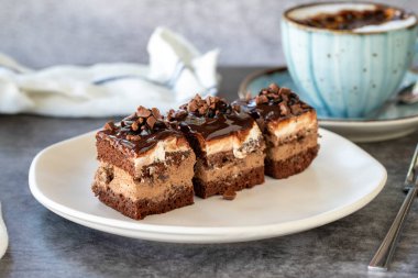Chocolate tartlet. Small chocolate cake in a plate. On dark floor. close up