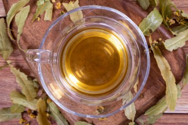 Linden tea. Linden tea on wood floor. Herbal tea concept. Healthy drinks. Top view. close up