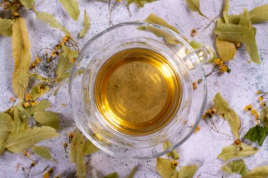 Linden tea. Linden tea on stone background. Herbal tea concept. Healthy drinks. Top view. close up