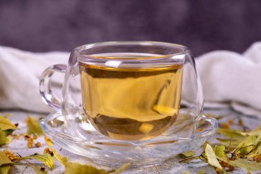 Linden tea. Linden tea on stone background. Herbal tea concept. Healthy drinks. close up