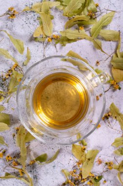 Linden tea. Linden tea on stone background. Herbal tea concept. Healthy drinks. Top view. close up