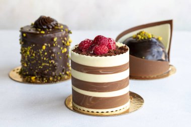 Types of cakes. Small sweet cakes on a white background. Bakery products. close up