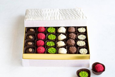 Packed chocolate. Assortment of packed truffle chocolates on a white background. close up