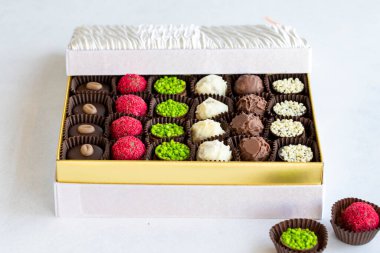 Packed chocolate. Assortment of packed truffle chocolates on a white background. close up
