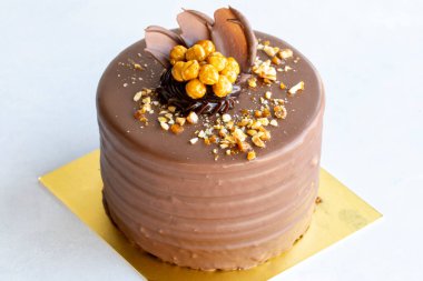 Croquant cake. Celebration cake with liquid chocolate, cream and croquant on a white background. close up